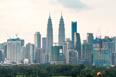 Modern buildings in city against sky