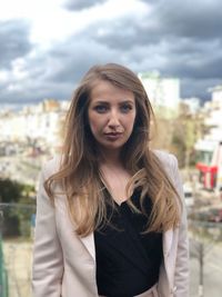 Portrait of beautiful businesswoman standing in city