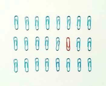 High angle view of paper clips over white background