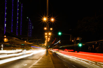 Light trails on road in city at night