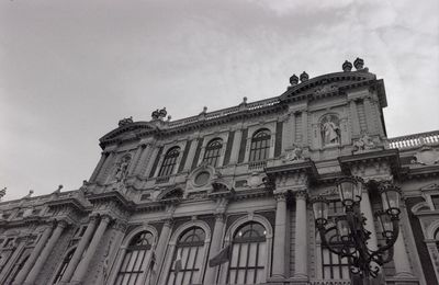 Low angle view of historical building against cloudy sky