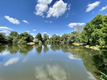 Scenic view of lake by trees against sky