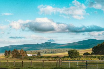 Scenic view of landscape against cloudy sky