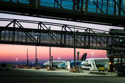 Illuminated bridge against sky at sunset