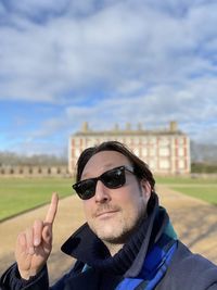 Portrait of man wearing sunglasses against sky