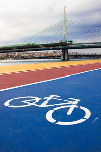 View of blue bicycle path and bridge