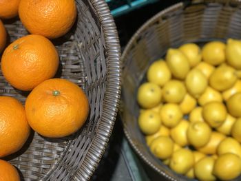 High angel view of freshness orange and blurred a pile of lemons in basket.