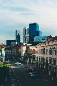 View of city street and buildings against sky