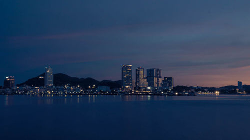 Seascape with building on background and small mountain at dusk in sriracha chonburi thailand