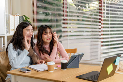 Young woman using laptop while sitting at home