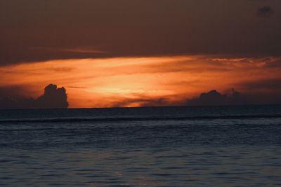 Scenic view of sea against orange sky