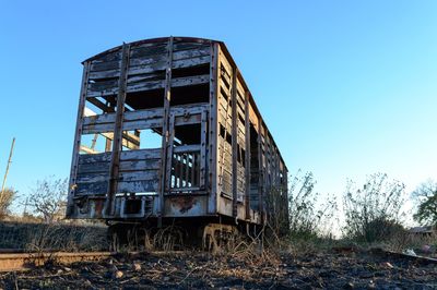 Low angle view of abandoned building against clear sky