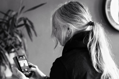 Side view of woman photographing with camera