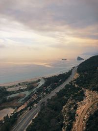 High angle view of city by sea against sky