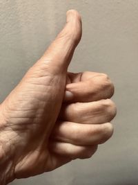 Close-up of person hand over white background