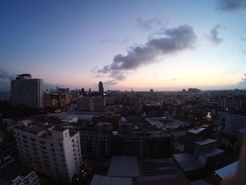 High angle view of buildings in city against sky during sunset