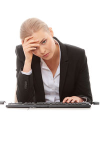 Young woman using mobile phone against white background