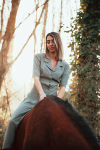 Young woman riding horse