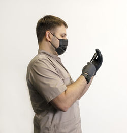 Man photographing against white background