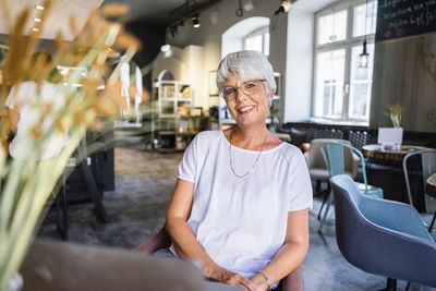 Portrait of smiling woman sitting in cafe