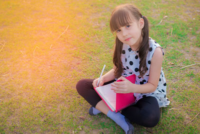 Portrait of girl sitting on grass