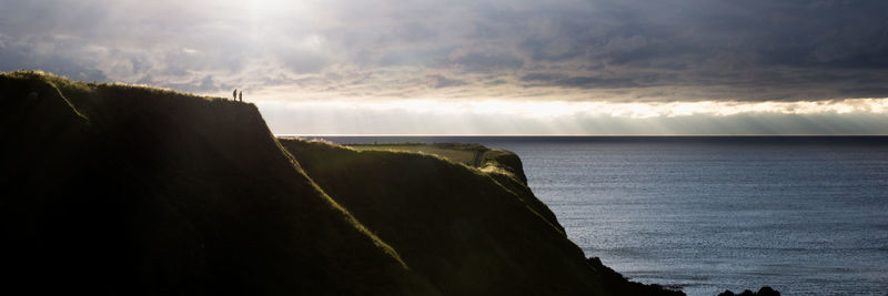 View of calm sea against dramatic sky