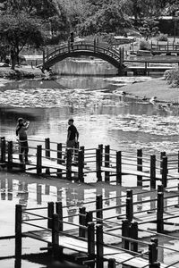 People standing on bridge over river