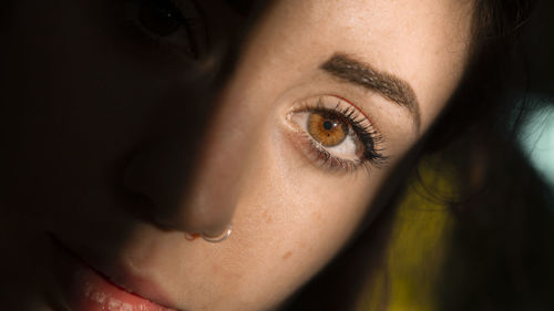 Close-up portrait of young woman at home