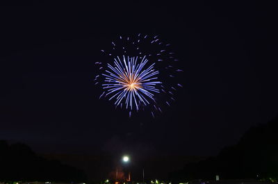 Low angle view of firework display at night