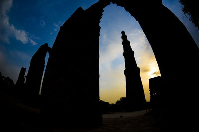Silhouette of statues at sunset