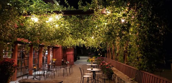 Empty chairs and table in restaurant at night