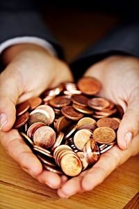 Cropped hand of man holding coins