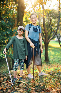 Full length of father and son on land