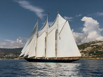 Sailboat sailing in sea against sky