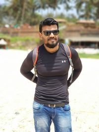 Young man wearing sunglasses standing outdoors