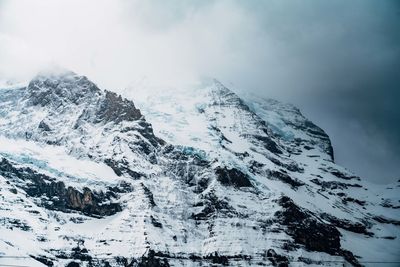 Scenic view of snow covered mountains against sky