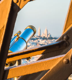 Close-up of coin-operated binoculars against the sky