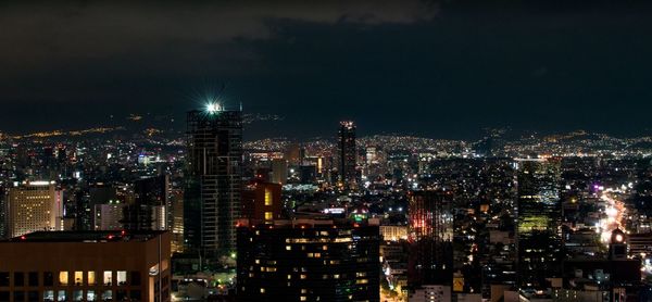 High angle view of city lit up at night