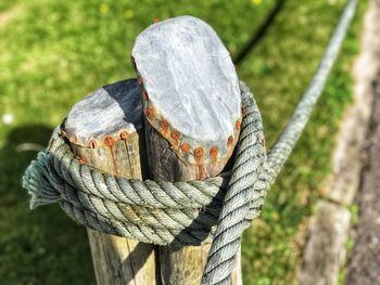 Close-up of rope tied to wooden post