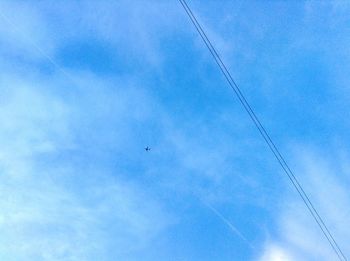 Low angle view of birds flying in sky
