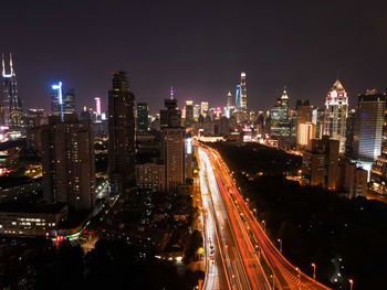 High angle view of illuminated city buildings at night