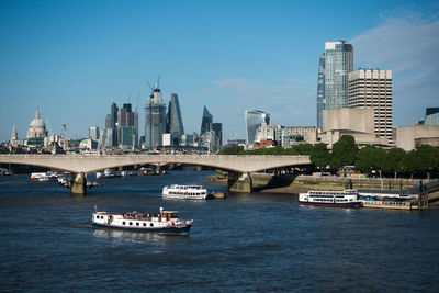 Bridge over river with buildings in background