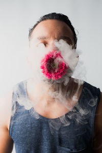 Man with flower emitting smoke