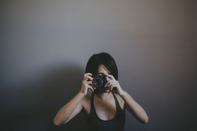 Portrait of woman photographing