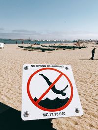 Warning sign at sandy beach 