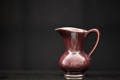 Close-up of drink on table against black background