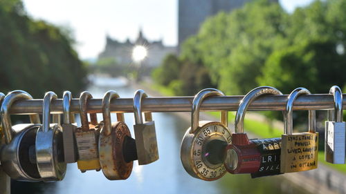 Close-up of padlocks hanging on railing
