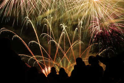 Low angle view of firework display at night