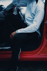 Low section of man sitting on floor