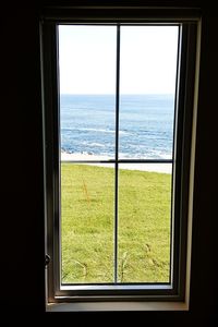 Close-up of sea seen through window